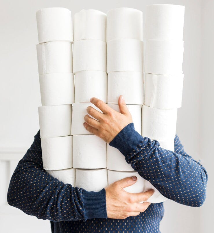 man-with-stack-toilet-paper