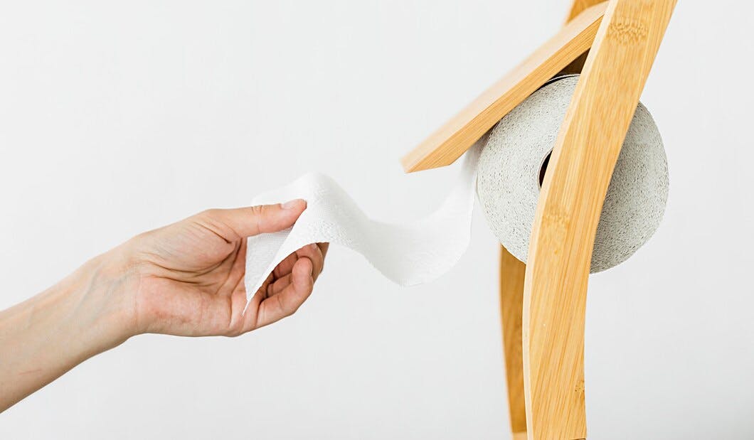 side-view-hand-pulling-toilet-paper